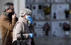 Relatives attend the funeral of a woman who died from coronavirus disease (COVID-19), as Italy struggles to contain the spread of coronavirus disease (COVID-19), in Seriate, March 28, 2020.
