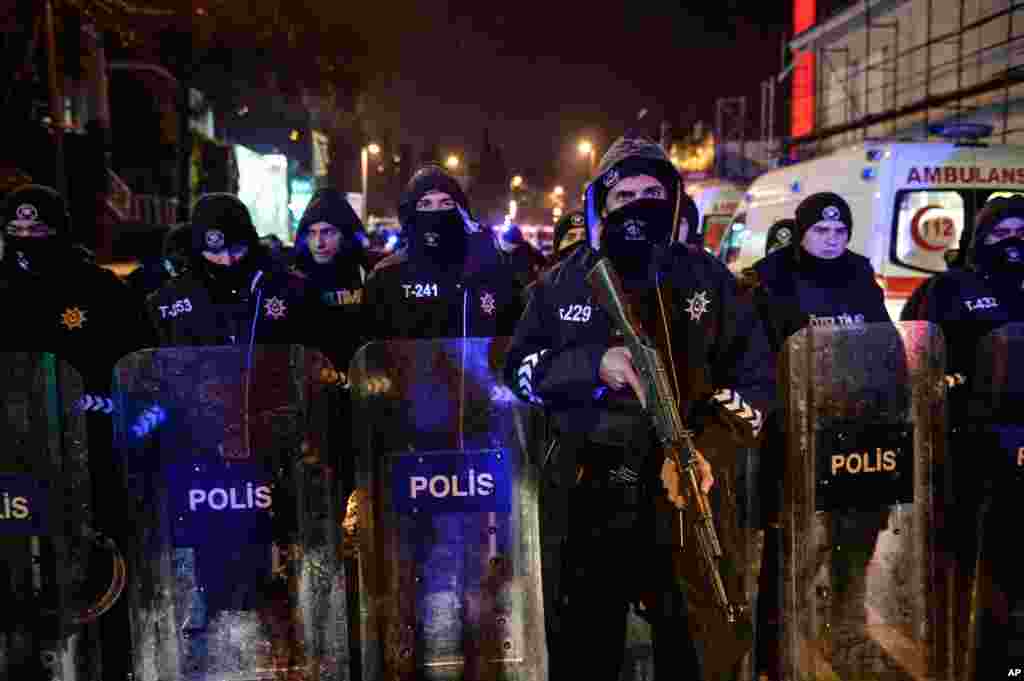 Turkish police officers block the road leading to the scene of an attack in Istanbul, early Jan. 1, 2017.