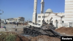 A burned tank belonging to government forces is seen in Azzaz, Aleppo province, Syria July 19, 2012.