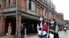 People wearing face masks to help curb the spread of the coronavirus walk on a street in Taipei, Taiwan, Monday, Oct. 19, 2020. (AP Photo/Chiang Ying-ying)
