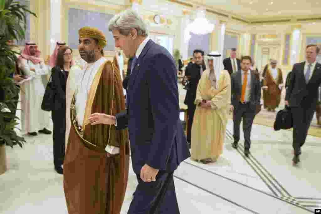 U.S. Secretary of State John Kerry walks with Yusuf bin Alawi bin Abdullah, Oman's Minister of Foreign Affairs, during a meeting of Gulf foreign ministers at Riyadh Air Base, Saudi Arabia, March 5, 2015.