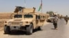 FILE - Afghan National Army (ANA) troops arrive in Nad Ali district of Helmand province, southern Afghanistan, Aug. 10, 2016.
