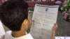 A man reads WhatsApp advertisements on how to spot misinformation, published in prominent newspapers in New Delhi, India, July 10, 2018.