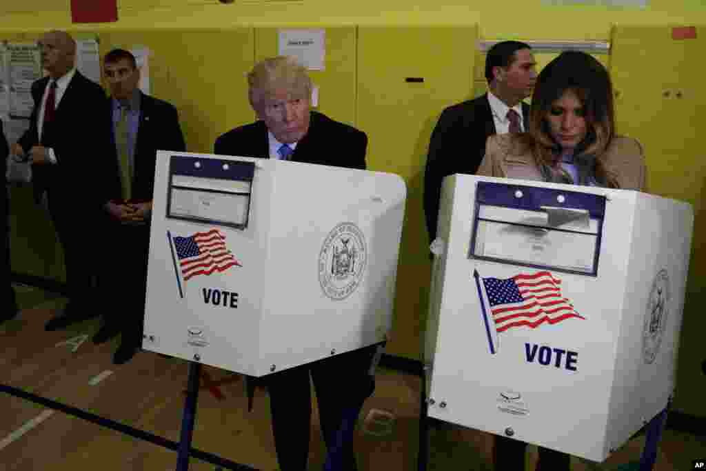 Kandidat presiden AS dari Partai Republik Donald Trump, dan istrinya Melania, memberikan suaranya di TPS PS-59 di kota New York (8/11). (AP/ Evan Vucci)