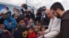 Paus Fransiskus (dua dari kanan) berbicara dengan para pengungsi di Pusat Penerimaan dan Identifikasi (RIC) di Mytilene di pulau Lesbos, Yunani, 5 Desember 2021. (Andreas SOLARO / AFP)