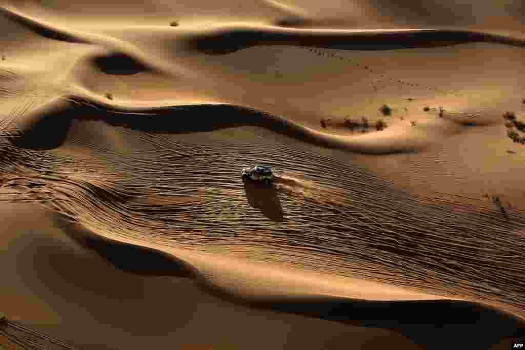 Mini team Yazeed Mohamed al-Rahji and copilot Timo Gottschalk compete in Inner Mongolia's Gobi desert, ending the 13th special stage of the Silkway rally.