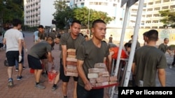 Personnel from the Chinese People's Liberation Army barracks in Hong Kong are seen on city streets Nov. 16, 2019, joining clean-up efforts after a week of violent protests. (AFP Photo/HKFP)