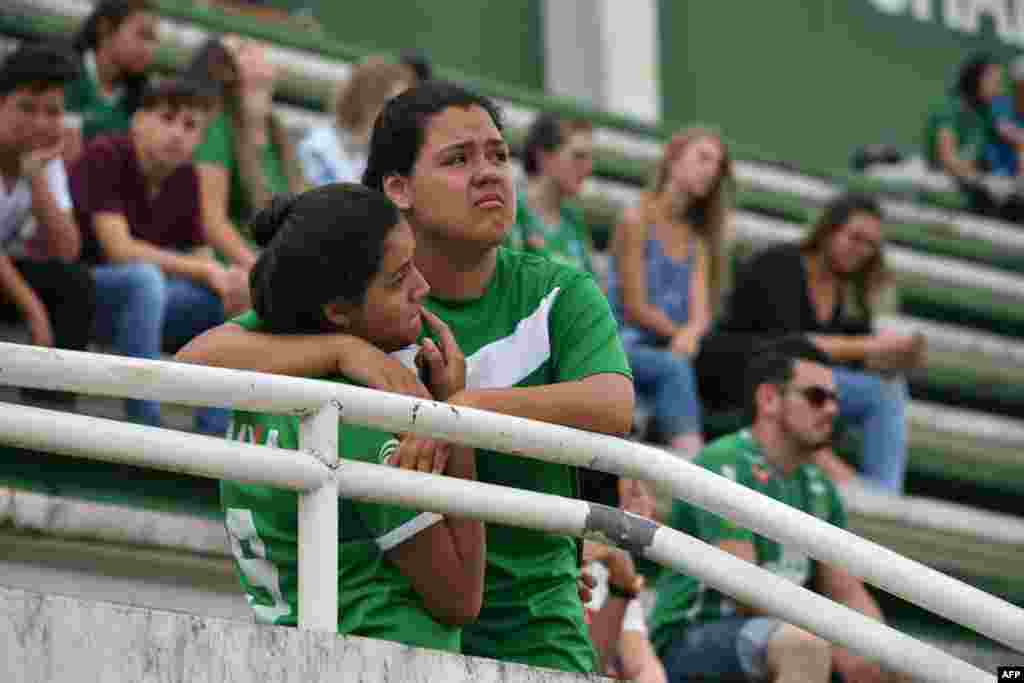 People pay tribute to the players of Brazilian team Chapecoense Real who were killed in a plane accident in the Colombian mountains, at the club's Arena Conda stadium in Chapeco, in the southern Brazilian state of Santa Catarina.