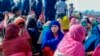 FILE - Rohingya refugees wait in an area following a boat capsizing accident, in Teknaf, Febr. 11, 2020.
