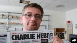 Parmi les morts: Stéphane Charbonnier, dit « Charb », qui était le directeur de Charlie Hebdo (AP)