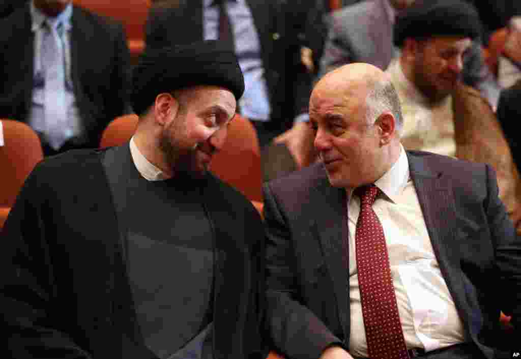 Iraq's incoming Prime Minister Haider al-Abadi, right, and Ammar al-Hakim, the leader of the Supreme Islamic Council of Iraq, during the session to approve the new government in Baghdad, Iraq, Sept. 8, 2014.