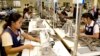 FILE - Cambodian garment workers sew clothes in a factory in Phnom Penh, Cambodia, Aug. 4, 2007. 
