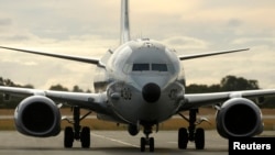 FILE - A U.S. Navy P8 Poseidon aircraft returns from a search flight for Malaysia Airlines flight MH370 over the Indian Ocean, at Perth International Airport.