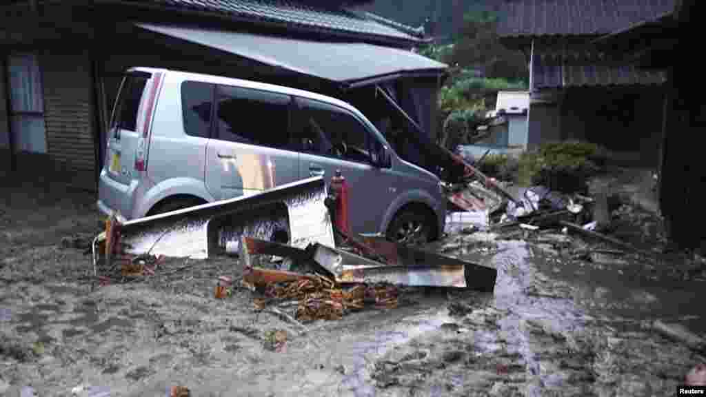 Cars and buildings damaged by a landslide caused by heavy rains set off by Typhoon Neoguri are seen in Nagiso town, Nagano Prefecture, in this photo taken by Nagano Prefecture, July 9, 2014.