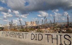 FILE - Words are written by Lebanese citizens in front of the scene of the massive explosion that hit the seaport of Beirut, Lebanon, Aug. 9, 2020.