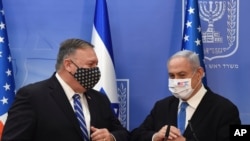 U.S. Secretary of State Mike Pompeo and Israeli Prime Minister Benjamin Netanyahu wear face masks to help prevent the spread of the coronavirus after they make joint statements to the press, in Jerusalem, Aug. 24, 2020.