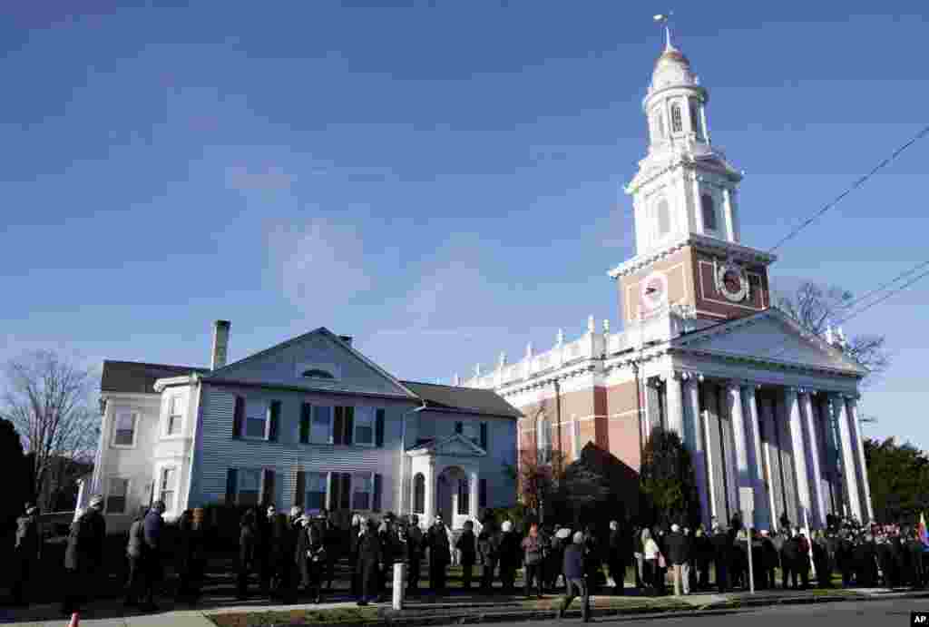 A long line stretches down the block in front of the First Congregational Church before a memorial service for Lauren Rousseau in Danbury, Connecticut, December 20, 2012.