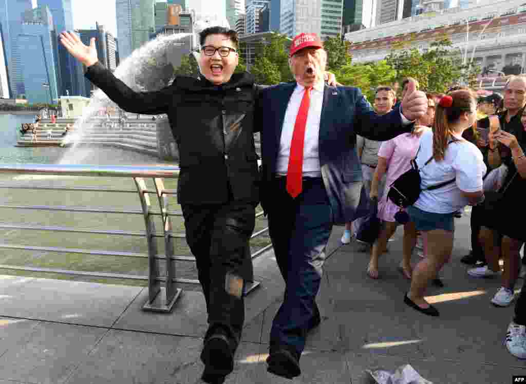 Howard, dan kasar Australia-dan asalin kasar China ya yi shigar shugaban Koriya Ta Arewa Kim Jong-un, da Dennis Alan, wanda ya yi shigar shugaban Amurka Donald Trump, sun gana a wurin shakatawa na Merlion Park a Singapore, June 8, 2018.