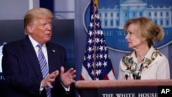 FILE - President Donald Trump asks a question of Dr. Deborah Birx, White House coronavirus response coordinator, during a briefing about the coronavirus in the James Brady Briefing Room, March 23, 2020, in Washington.