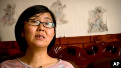 FILE - In this April 18, 2015 photo, Wang Yu, a lawyer for Chinese activist Li Tingting, speaks during an interview in Beijing.