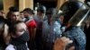 FILE - Riot police stand guard during a demonstration against the political leadership the protesters blame for the economic and financial crisis, in front of the Ministry of Economy, in downtown Beirut, Lebanon, June 6. 2021.