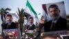 Supporters hold posters of Egypt's Islamist President Mohammed Morsi during a rally near Cairo University Square in Giza, Egypt, Tuesday, July 2, 2013. Egypt was on edge Tuesday following a "last-chance" ultimatum the military issued to Mohammed Morsi, gi