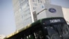 A bus passes in front of a Ford logo near a sales store of the automaker in Mexico City, Mexico, April 5, 2016.