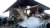 Emergency and security personnel are seen at the site of a plane crash near Almaty, Kazakhstan, Dec. 27, 2019. 