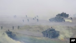 FILE - Soldiers participate in the annual Han Kuang military exercises that simulate an anti-landing operations near the coast in New Taipei City, northern Taiwan, July 27, 2023. 
