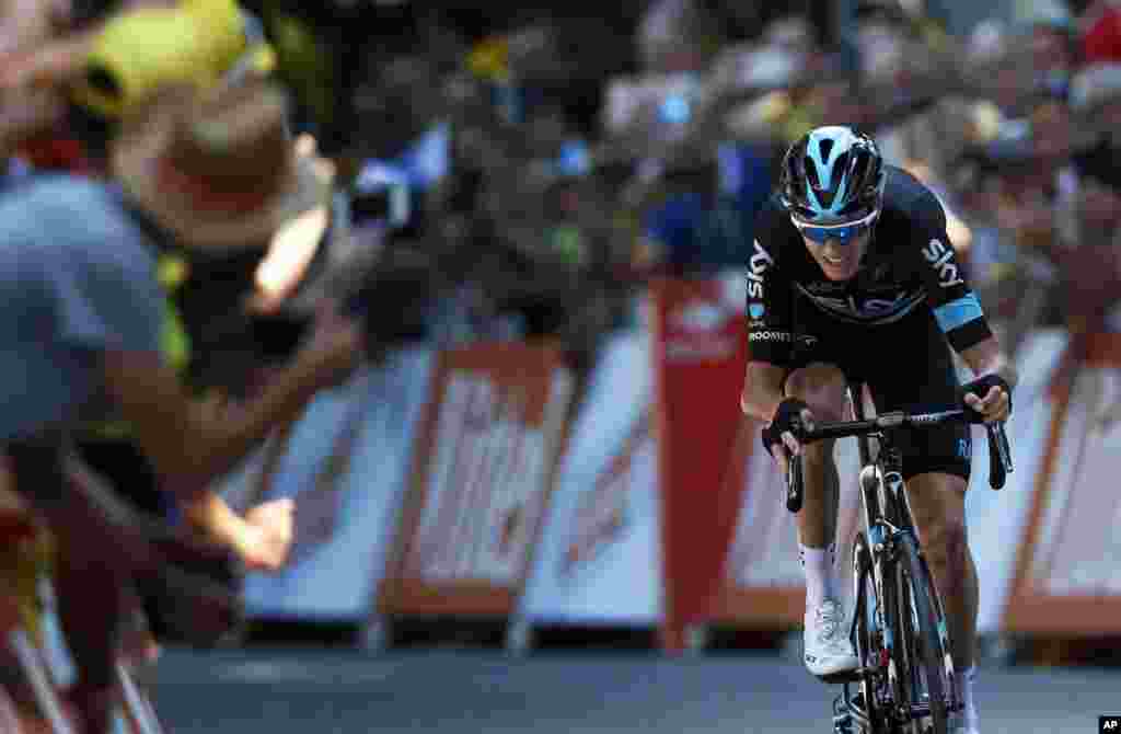 Spectators cheer Britain’s Chris Froome as he rides to win the eighth stage of the Tour de France cycling race over 184 kilometers (114.3 miles) with start in Pau and finish in Bagneres-de-Luchon, France.