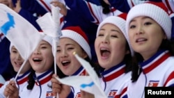North Koreans attend the women's preliminary round ice hockey match between Sweden and the Unified Korean team druing the Pyeongchang 2018 Winter Olympics in Gangneung, South Korea, Feb. 12, 2018.