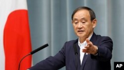 FILE - Japan's Chief Cabinet Secretary Yoshihide Suga speaks to VOA's Steven Herman, Tokyo, Japan, Feb. 4, 2013.