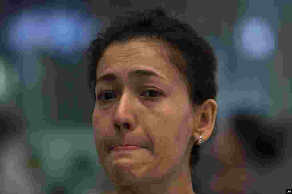 Guzulnur cries as she bids farewell to friends at the Capital Airport in Beijing, China, Sept. 15, 2014. 