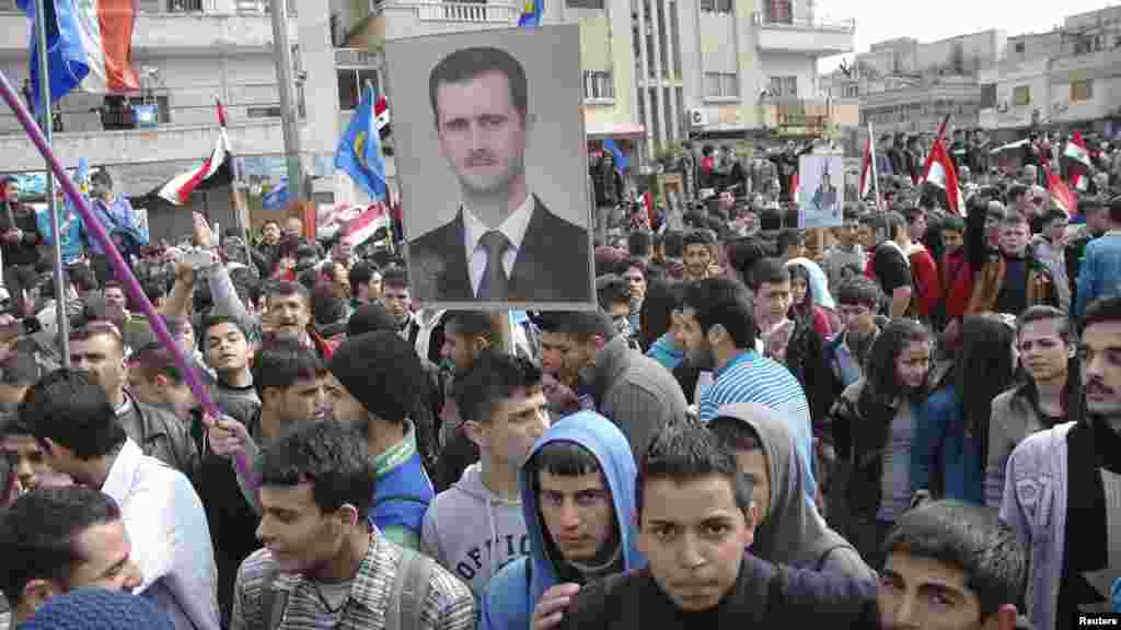 Supporters of Syrian President Bashar al-Assad rally in Homs, Feb. 11, 2014, in this handout photograph released by SANA.