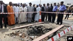 Nigerian President Goodluck Jonathan (C, with black hat) visits St. Theresa's Catholic church, the scene of a Christmas day bomb attack, just outside the capital Abuja, (file photo)