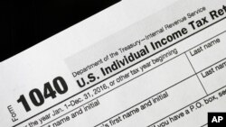 FILE - A 1040 tax form on display in New York, Jan. 10, 2017.
