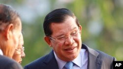 លោកនាយករដ្ឋមន្ត្រី ហ៊ុន សែន (ខាង​ស្តាំង) សំណេះ​សំណាលជាមួយ​នឹង​មេដឹកនាំ​កំពូល​នៃ​គណបក្សលោក មុន​ពេល​ចូលរួម​ពិធី​គម្របខួប៣៦ឆ្នាំ​នៃ​ការ​ដួលរលំនៃ​របបខ្មែរក្រហម​នៅ​ទីស្នាក់ការ​កណ្តាល​របស់​គណបក្ស​ប្រជាជនកម្ពុជាកាល​ពី​ថ្ងៃ​ពុធ ទី៧ ខែ​មករា ឆ្នាំ២០១៥។ (រូបថត៖ AP/ហេង ស៊ីនិត)