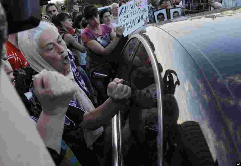 People block a car carrying Russian Ambassador in Ukraine Mikhail Zurabov and Ukrainian lawmaker Nestor Shufrich after a meeting with leaders of the self-proclaimed Donetsk People's Republic and Luhansk People's Republic in Donetsk, Ukraine, June 23, 2014.