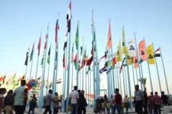 FILE - People attend the Damascus International Trade Fair in the Syrian capital, Aug. 30, 2019.