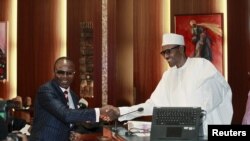Ibe Kachikwu, ministre nigérian du pétrole et directeur-général de la 'Nigerian National Petroleum Corporation' (NNPC) avec le président Muhammadu Buhari (à droite) lors d'une cérémonie d'investiture à Abuja, au Nigeria, le 11 novembre 2015. (REUTERS/Afolabi Sotunde)