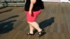 FILE - A woman walks along a boardwalk in New York. Lifestyle and lack of access to health care have been among the factors attributed to a rise in the mortality rate of white women in the United States.