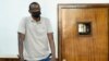 FILE - Ugandan author Kakwenza Rukirabashaija appears before a court in a failed bid to have his passport returned, in Kampala, Uganda, Feb. 1, 2022.