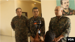 SDF general commander Mazlum Abdi, center, speaks during a press conference in Kobani, Syria, July 22, 2019. (S. Kajjo/VOA video grab)