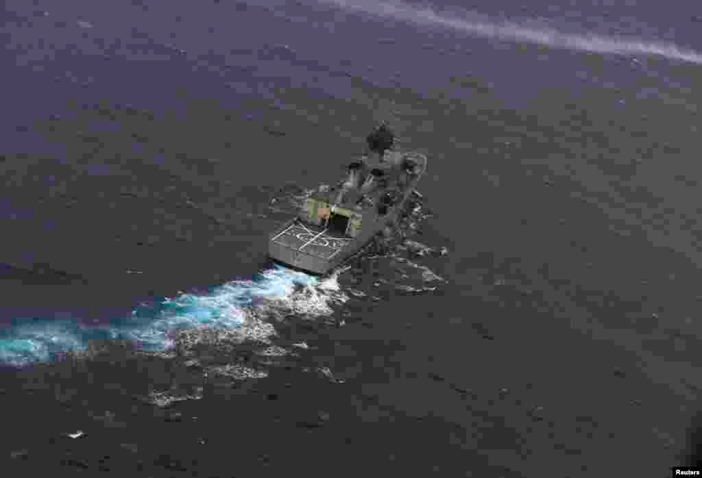 The Royal Australian Navy ship HMAS Perth is guided into position by a Royal New Zealand Air Force aircraft as the search continues for Flight MH370, April 13, 2014.