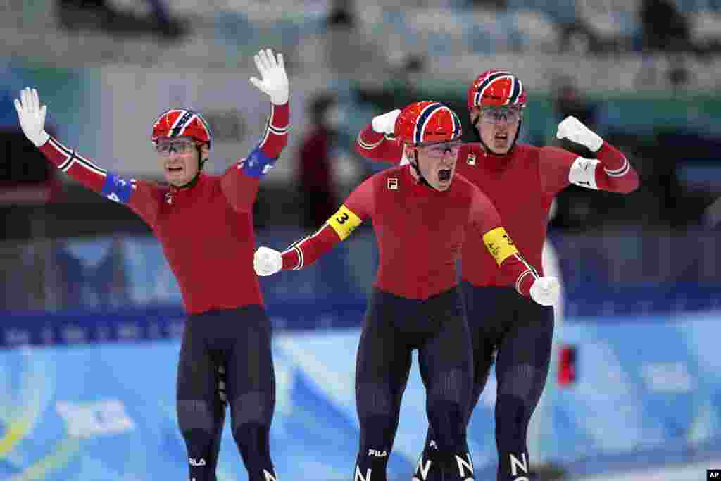 Team Norway&#39;s Peder Kongshaug, center, Sverre Lunde Pedersen, left, and Hallgeir Engebraaten react after winning the gold medal in the speedskating men&#39;s team pursuit finals at the 2022 Winter Olympics in Beijing.