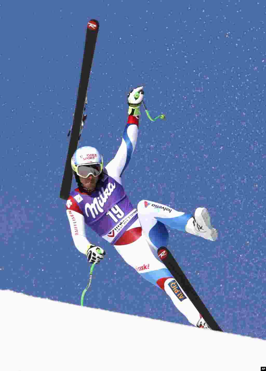Carlo Janka of Switzerland loses his ski and crashes during the alpine ski, men's World Cup super-G race, at the World Cup finals in Meribel, France.