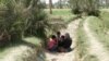 Displaced Iraqis from Ramadi wait in the open, as security forces close the Bzebiz bridge for security reasons, to prevent them from crossing to the capital, May 18, 2015.