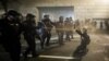 Demonstrators huddle and blow back tear gas with leaf blowers during clashes with federal officers during a police brutality protest at the Mark O. Hatfield United States Courthouse July 29, 2020, in Portland, Ore.