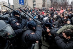 FILE - Law enforcement officers clash with participants during a rally in support of jailed Russian opposition politician Alexei Navalny in Moscow, Russia, Jan. 23, 2021.