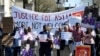 Demonstrators carry placards demanding justice for Asifa, an 8-year-old Muslim girl who was raped and murdered in India, during a rally protesting a visit by Indian Prime Minister Narendra Modi, in London, April 18, 2018. 
